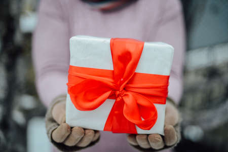 Extensive series of holiday shots with a variety of props and backgrounds. Lots of copyspace for ads. Christmas presents on wooden table. A couple of gifts wrapped in Christmas themed wrapping paper.の写真素材
