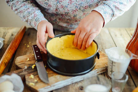 Close up view of baker kneading dough. Homemade bread. Hands preparing bread dough on wooden table. Preparing traditional homemade bread. Woman hands kneading fresh dough for making breadの写真素材
