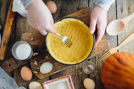 Close up view of baker kneading dough. Homemade bread. Hands preparing bread dough on wooden table. Preparing traditional homemade bread. Woman hands kneading fresh dough for making breadの写真素材