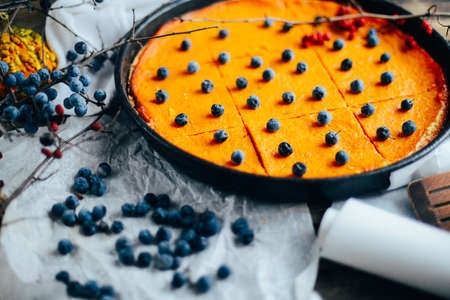 Pumpkin pie with autumn decorations on vintage wooden table.  Pumpkin pie, tart made for Thanksgiving day.  pumpkin pie with  cinnamon on rustic backgroundの写真素材