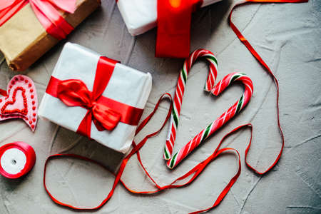 Valentine's Day concept. Gift with red bow  on the wooden background, Valentines. Valentines gift boxes tied with a red satin ribbon bow on  background. gift on , wedding dayの写真素材