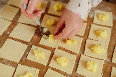 Making of pierogi with potato Vareniki. Russian food . Rustic style. Vareniki dumplings, pierogi before boiling traditional Ukrainian food. Dumpling recipe.の写真素材