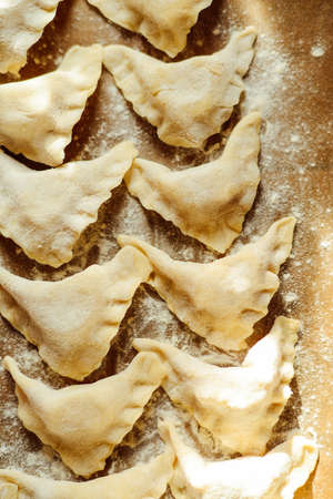 Making of pierogi with potato Vareniki. Russian food . Rustic style. Vareniki dumplings, pierogi before boiling traditional Ukrainian food. Dumpling recipe.の写真素材