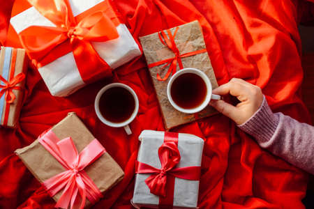 Valentine's Day concept. Gift with red bow  on the wooden background, Valentines. Valentines gift boxes tied with a red satin ribbon bow on  background. gift onの写真素材