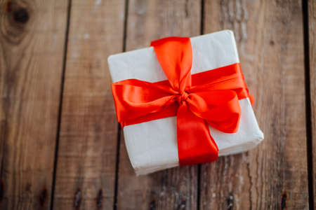 Valentine's Day concept. Gift with red bow  on the wooden background, Valentines. Valentines gift...