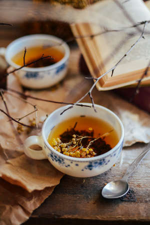 Cup of tea , rustic style.  cup of tea with spices and lemon on a wooden background. Cup coffee on a wooden background. Cup of tea with autumn decor on wooden table.の写真素材