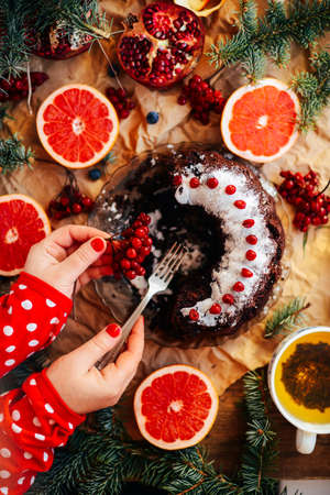fresh baked chocolate pie slice on rustic table setting. Rustic wooden background with cup of coffee, tart. vintage dinnerware and spoon. Breakfast at summer morning. Top view.の写真素材