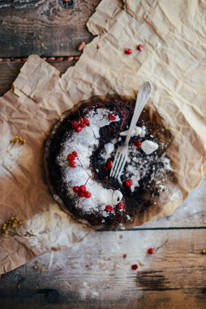 fresh baked chocolate pie slice on rustic table setting. Rustic wooden background with cup of coffee, tart. vintage dinnerware and spoon. Breakfast at summer morning. Top view.の写真素材
