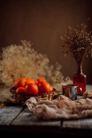 Basket of Tangerines on a wooden table.  Delicious and beautiful Tangerines.  Citrus background.  Mandarins Tangerine Closeup. Rustic styleの写真素材