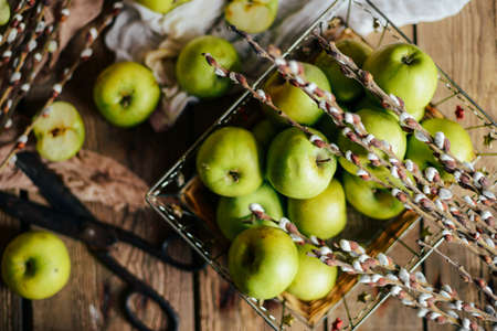ripe green apples and apple slices on wooden gray background, top viewの写真素材