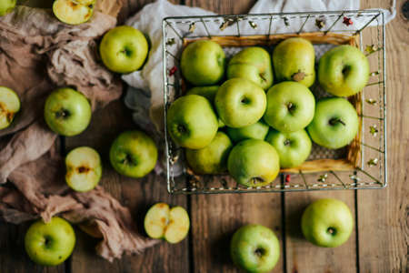 ripe green apples and apple slices on wooden gray background, top viewの写真素材