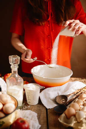 Ingredients for baking cake stuffed with fresh  pie. Female preparingpie. Rustic dark style. See series recipe step on step. Womans hands. Recipe for homemade pie on short pastryの写真素材
