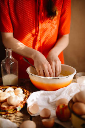 Ingredients for baking cake stuffed with fresh  pie. Female preparingpie. Rustic dark style. See series recipe step on step. Womans hands. Recipe for homemade pie on short pastryの写真素材