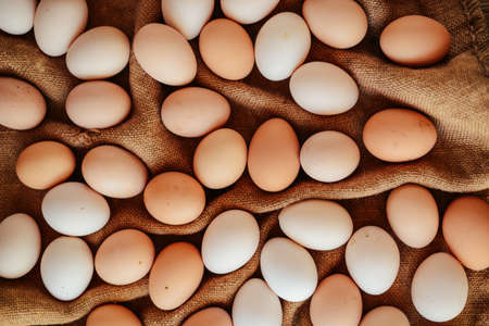 Close up of  eggs in a basket. top view of eggs in bowl. Brown eggs in wooden  bowl.Chicken Egg. ...