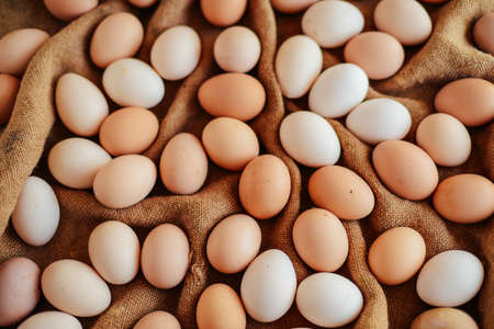 Close up of  eggs in a basket. top view of eggs in bowl. Brown eggs in wooden  bowl.
Chicken Egg.  Hen eggs baskeの写真素材
