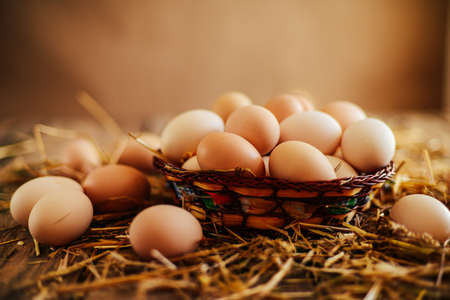 Close up of  eggs in a basket. top view of eggs in bowl. Brown eggs in wooden  bowl.
Chicken Egg.  Hen eggs baskeの写真素材