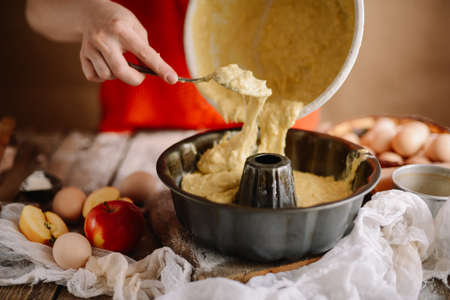 Ingredients for baking cake stuffed with fresh  pie. Female preparingpie. Rustic dark style. See series recipe step on step. Womans hands. Recipe for homemade pie on short pastryの写真素材