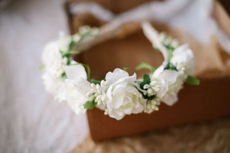 Handmade floral tiara made of  flowers lie on  wooden background. Fashionable hand made wreath of flowers head wear. Hand crafted fashion accessories for womenの写真素材