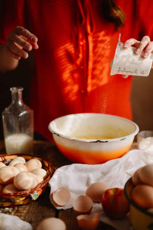 Ingredients for baking cake stuffed with fresh  pie. Female preparingpie. Rustic dark style. See series recipe step on step. Womans hands. Recipe for homemade pie on short pastryの写真素材