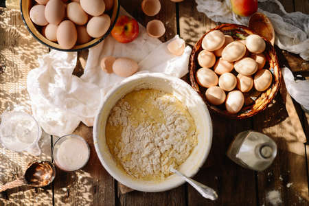 Ingredients for baking cake stuffed with fresh  pie. Female preparingpie. Rustic dark style. See series recipe step on step. Womans hands. Recipe for homemade pie on short pastryの写真素材