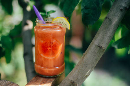 Assorted fruit shakes on white table. Smoothie concept. Selection of colorful smoothies on rustic wood background. Freshly blended fruit smoothies of various colors の写真素材