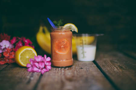 Assorted fruit shakes on white table. Smoothie concept. Selection of colorful smoothies on rustic wood background. Freshly blended fruit smoothies of various colorsの写真素材