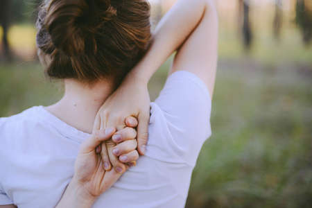 woman practices yoga and meditates in the lotus position on the nature. Girl Meditate at the forest. Woman meditating in the lotus position closeupの写真素材