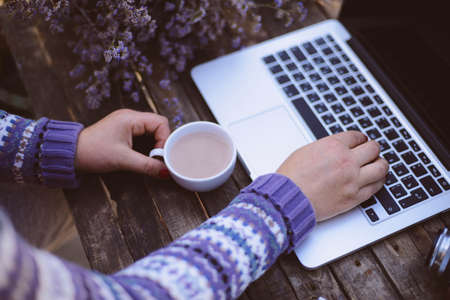 Woman working at home office hand on keyboard close upの写真素材