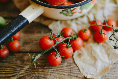 Fresh cherry tomatoes on rustic wooden table, Top view with copy space.の写真素材