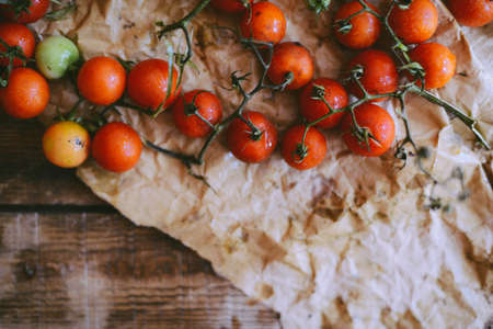 Fresh cherry tomatoes on rustic wooden table, Top view with copy space.の写真素材