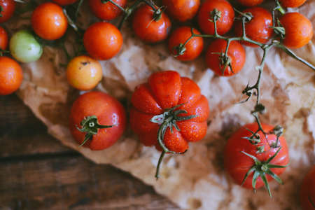 Fresh cherry tomatoes on rustic wooden table, Top view with copy space.の写真素材