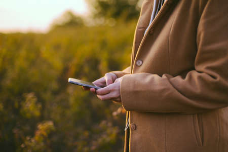 Beautiful young woman using smart phone outdoorの写真素材