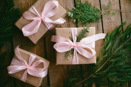 Lots of Gift boxes on wooden background. Presents in craft  paper decorated with  ribbon. Christmas and other holidays concept.の写真素材