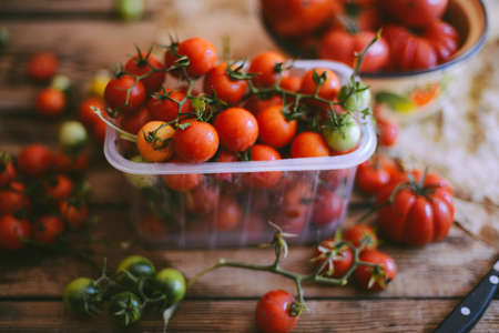 Fresh cherry tomatoes on rustic wooden table, Top view with copy space. の写真素材