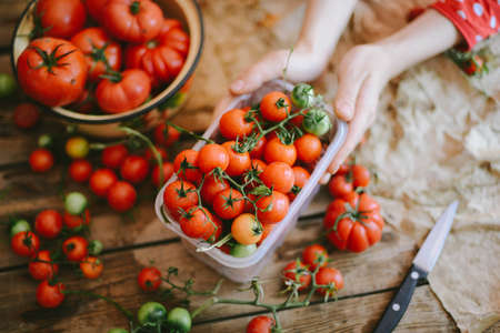 Fresh cherry tomatoes on rustic wooden table, Top view with copy space. の写真素材