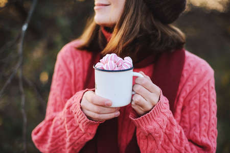 Woman Hands Holding Cup Beverage Hot Chocolate with marshmallow outdoor. Christmas New Year Concept