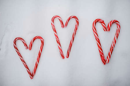 christmas hearts made of candy with toys isolated on white background, flat lay, top viewの写真素材