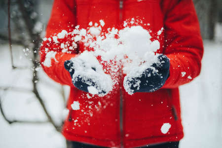 A young woman playing in the snowの写真素材