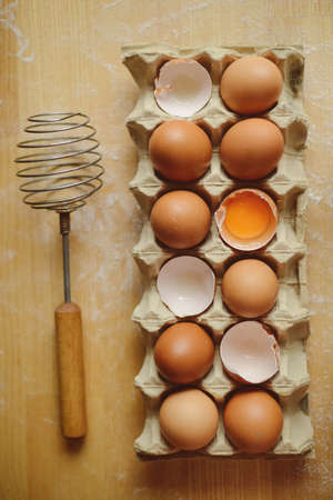 Ingredients for baking - flour, wooden spoon, rolling pin, eggs. Homemade tart pie preparation, dough with yeast and rolling pin on  rustic kitchen tableの写真素材
