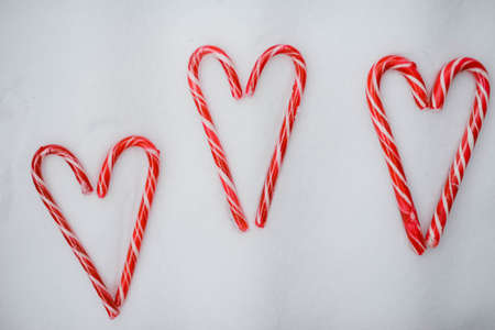 christmas hearts made of candy with toys isolated on white background, flat lay, top viewの写真素材