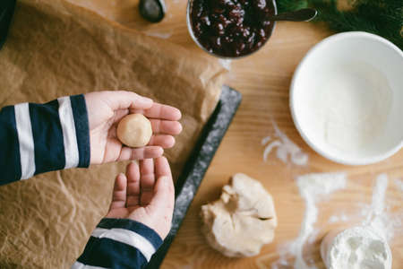 Ingredients for baking - flour, wooden spoon, rolling pin, eggs. Woman hands kneading fresh dough の写真素材