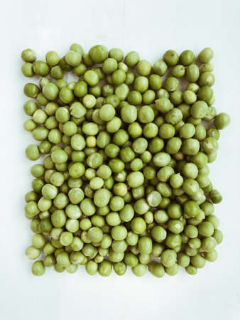 Pile of green wet pea isolated on white backgroundの写真素材