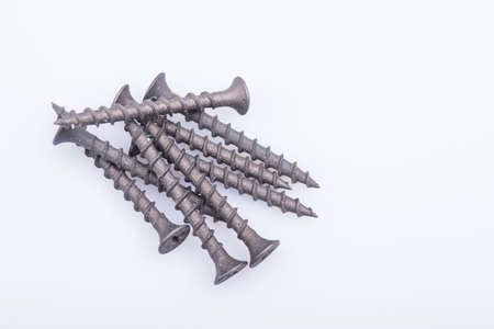 Wood screws piled up on white background