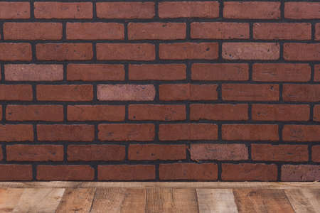 Brick wall background with wooden floor for backdropの写真素材