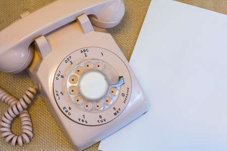 Vintage rotary phone with blank paperの写真素材