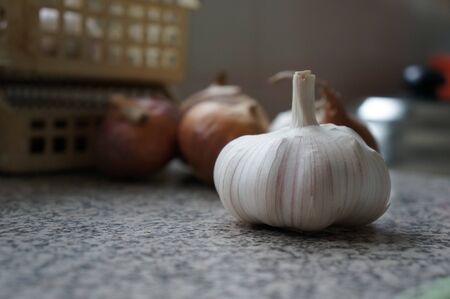 shot of garlic and onions in kitchenの写真素材