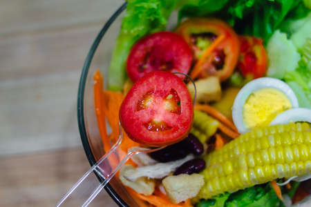 Close up of vegetable salad bowl and fork.Healthy eating, dieting, vegetarian kitchen and cooking.の写真素材
