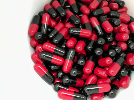 Red and black capsules in the bottleの素材