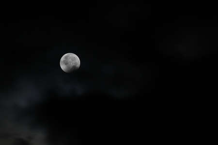 A bit of shadow remains from the total lunar eclipse on December 21, 2010 (winter solstice).の写真素材