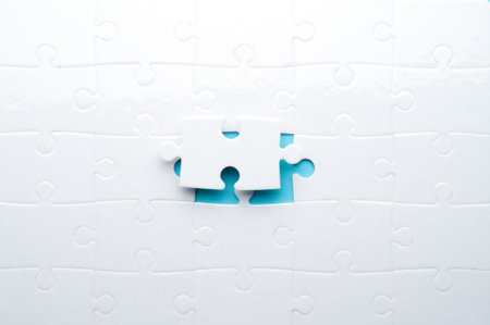 Concept for problem-solving, teamwork, solutions, or missing connections. White jigsaw puzzle on a vibrant blue background with one missing piece. Minimalist composition with copy space.の写真素材
